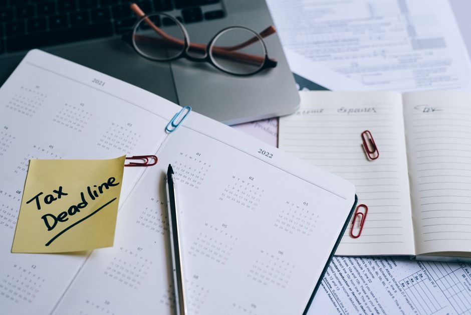 person studying accounting textbook desk calendar