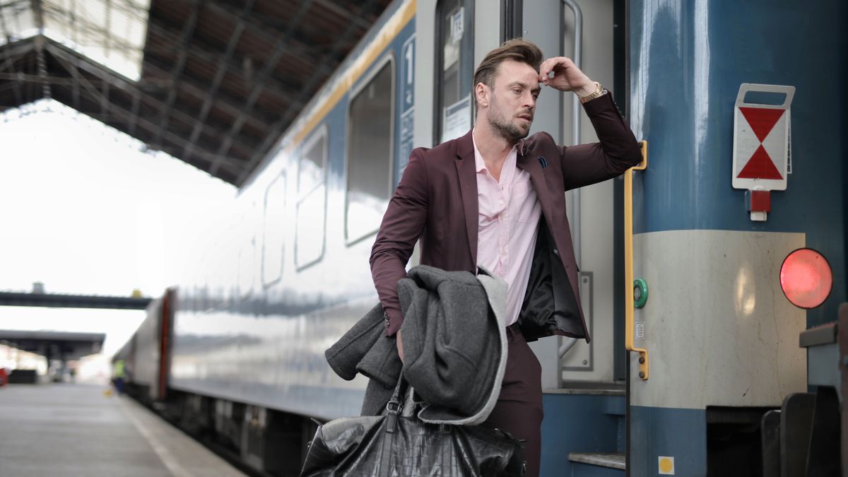 businessman studying english vocabulary on train commute