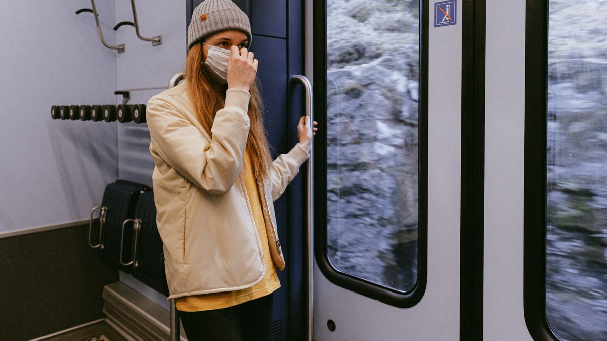 woman studying on smartphone during train commute