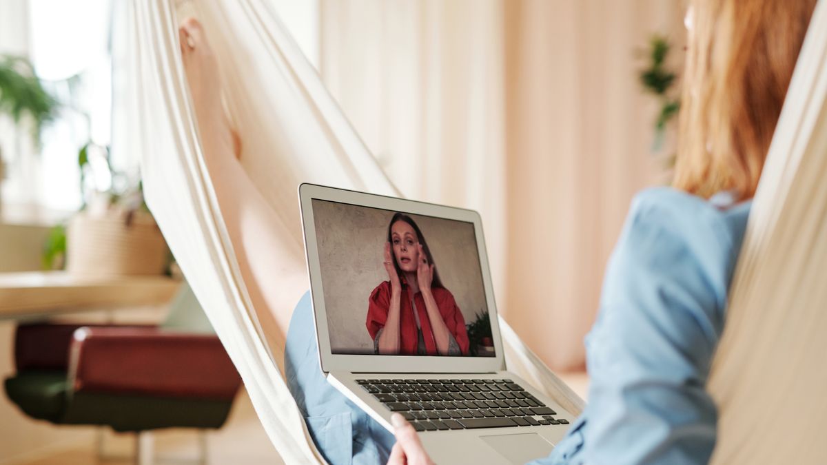 person watching online video lesson laptop relaxed