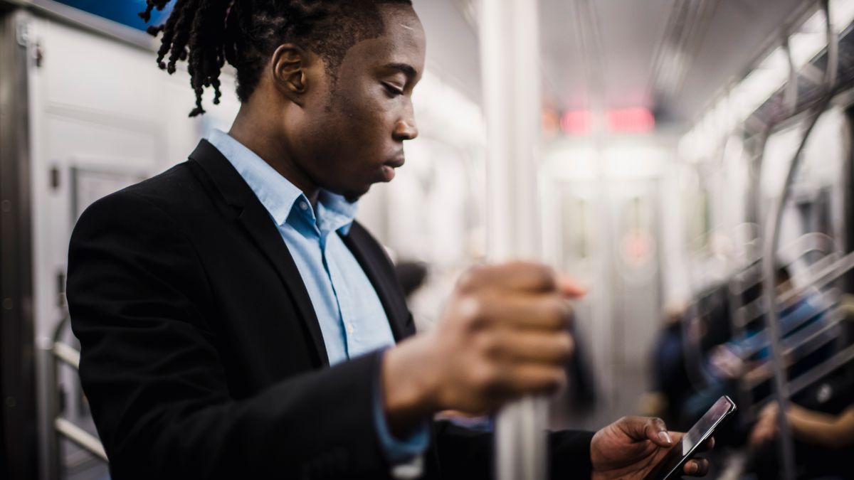 businessman studying smartphone commuter train