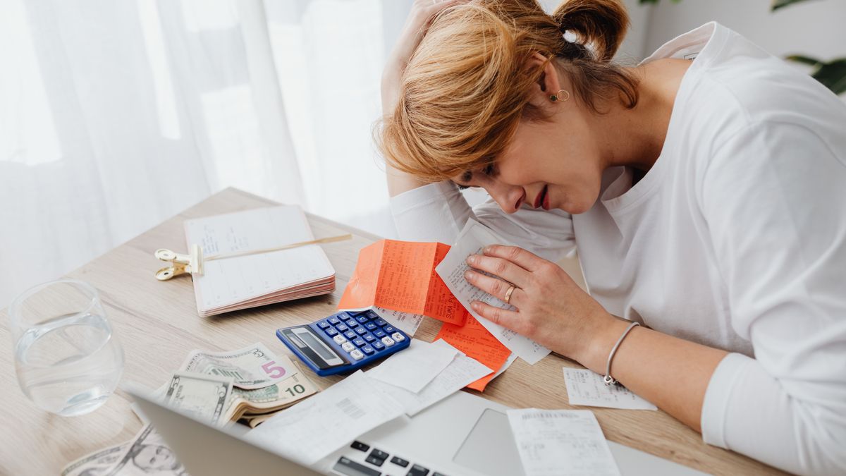 tired person studying medical billing paperwork at desk