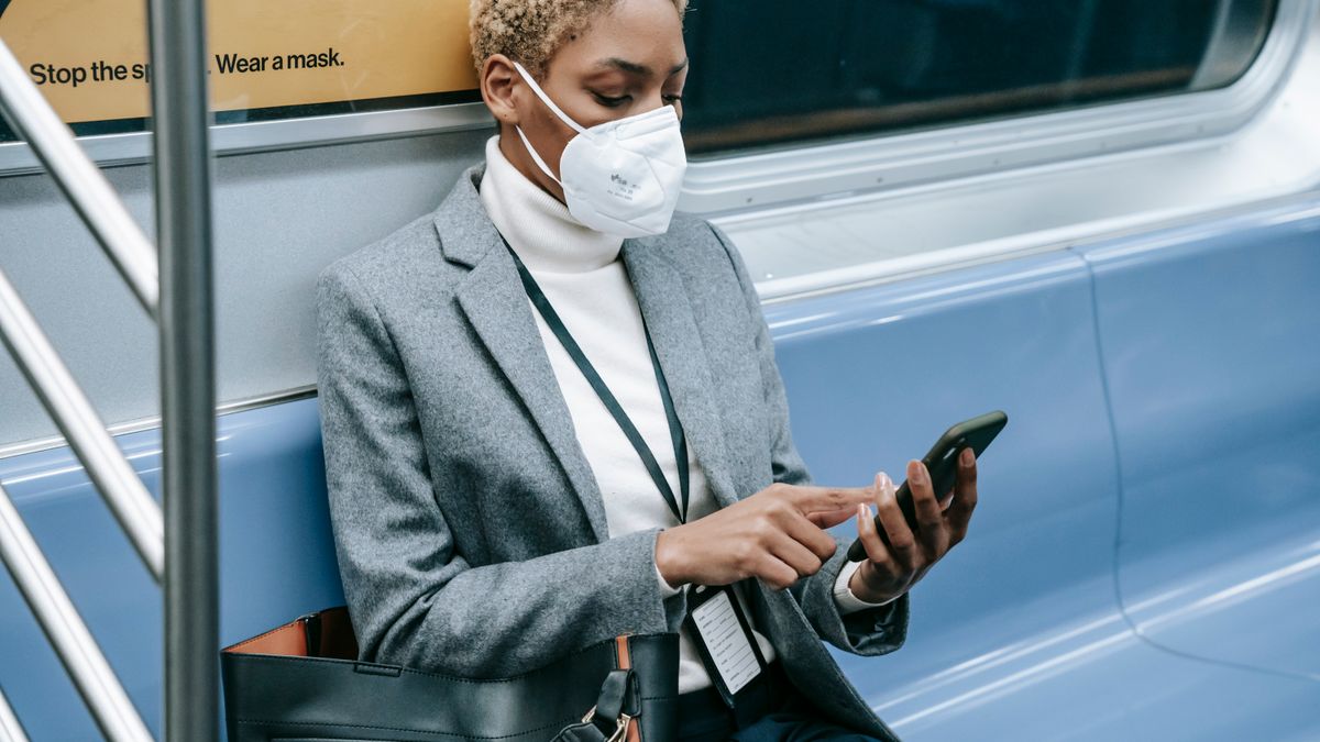 woman studying on smartphone during train commute