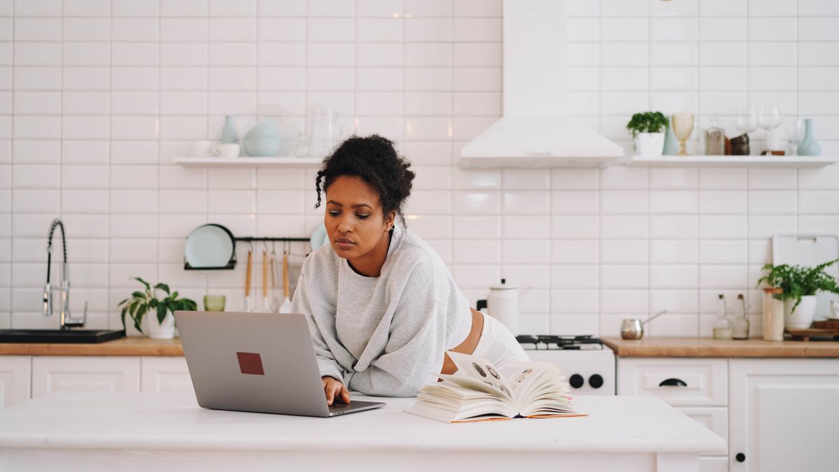woman studying online course on laptop at home