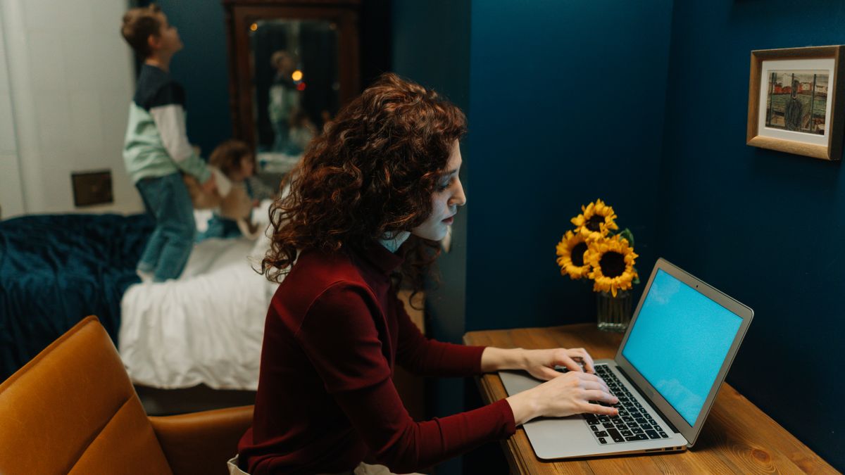 working mother studying at desk at night after children asleep