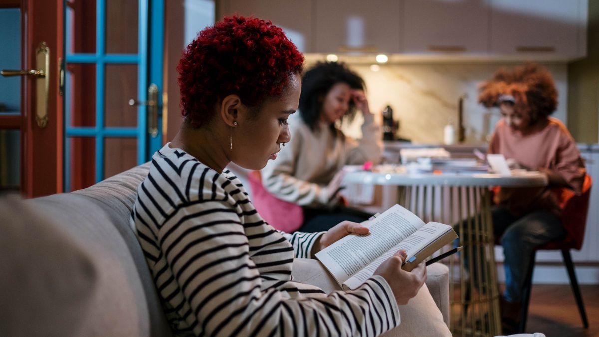 woman studying at kitchen table at night