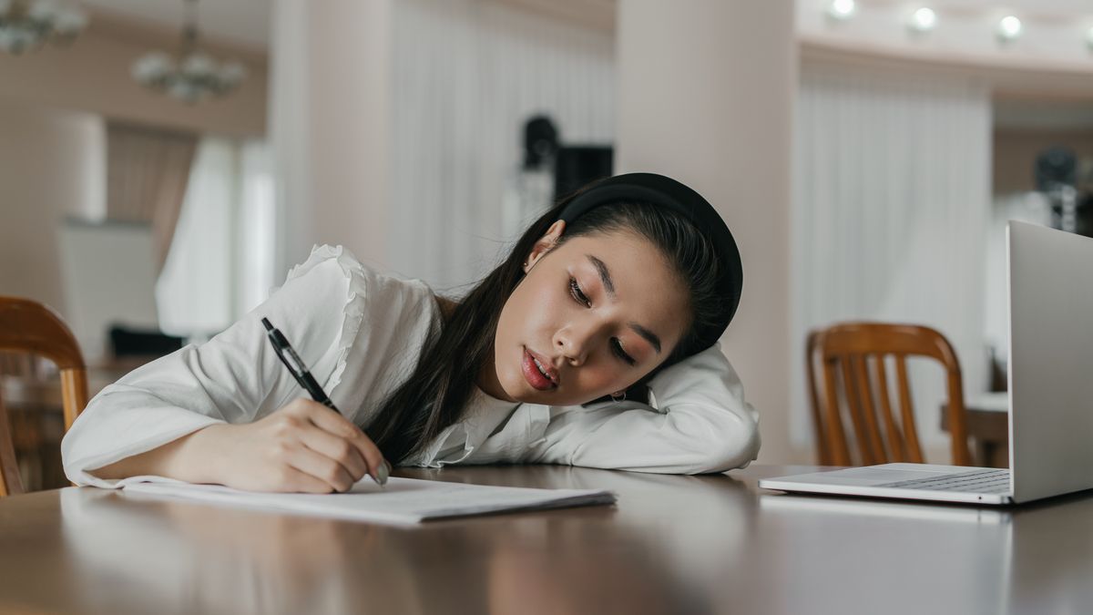 woman confused searching laptop exam past papers