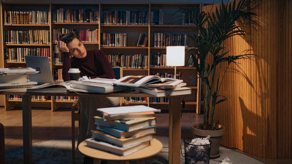 tired student studying late at night with books