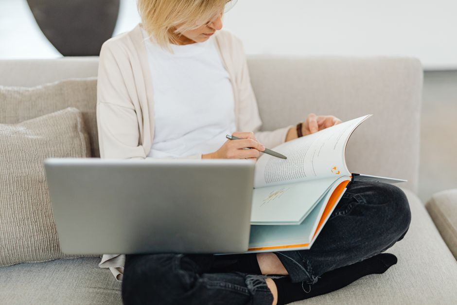 woman studying at home with textbook