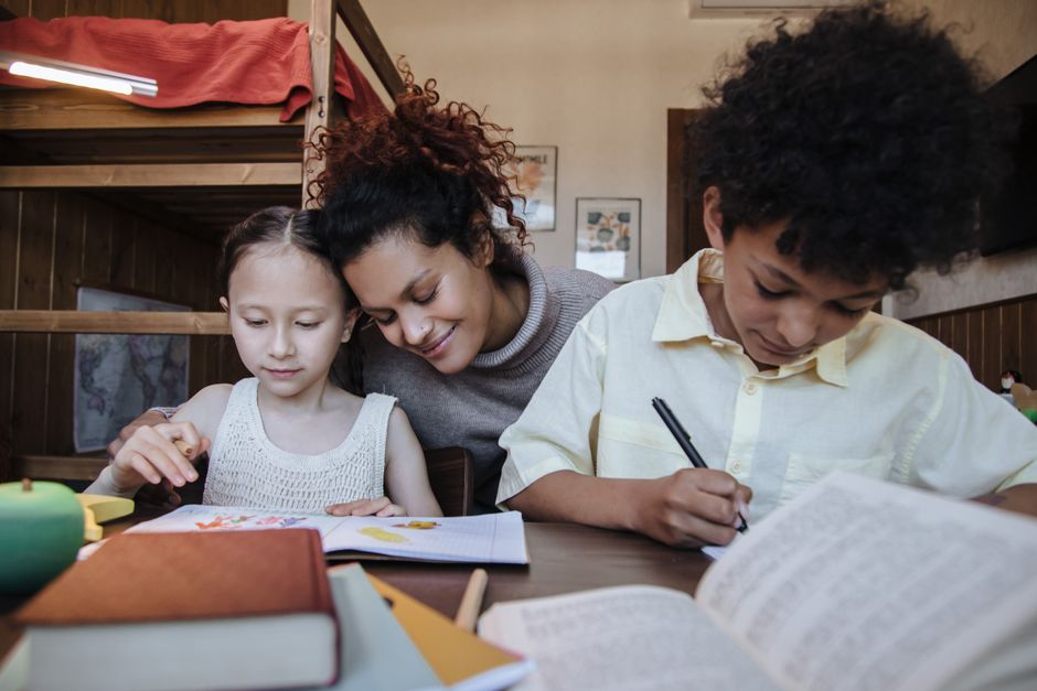 mother studying while children nap