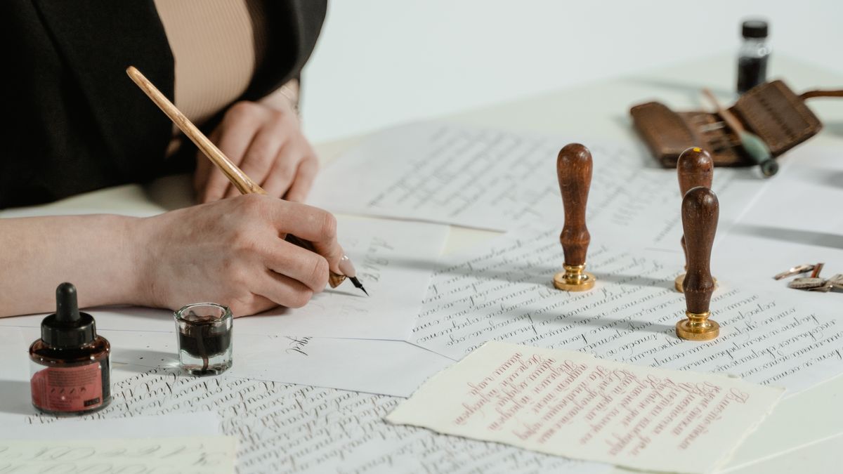 女性がビジネスデスクで手紙を書く様子