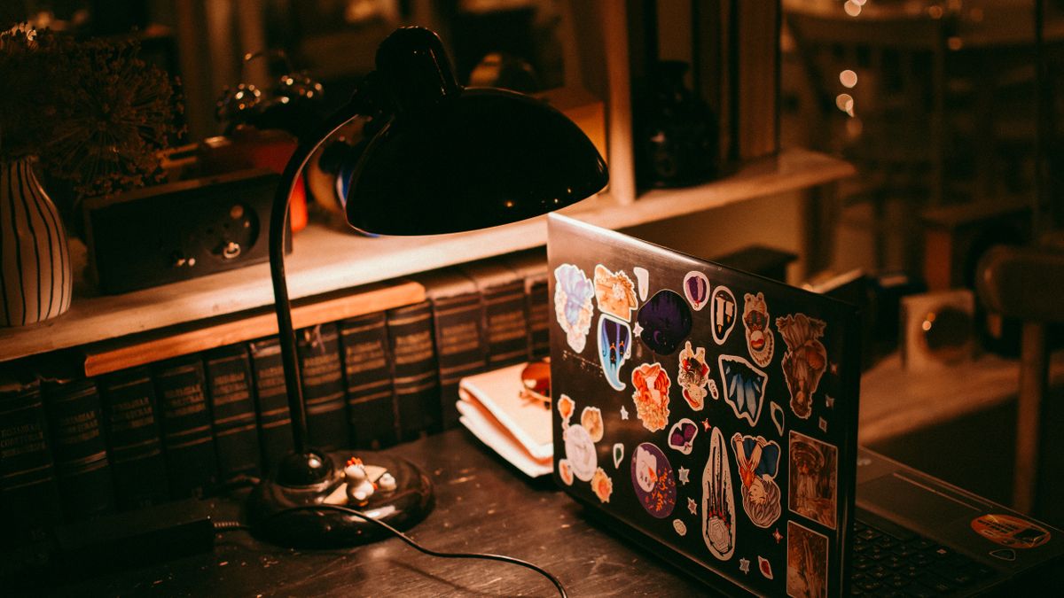 person studying at desk night lamp