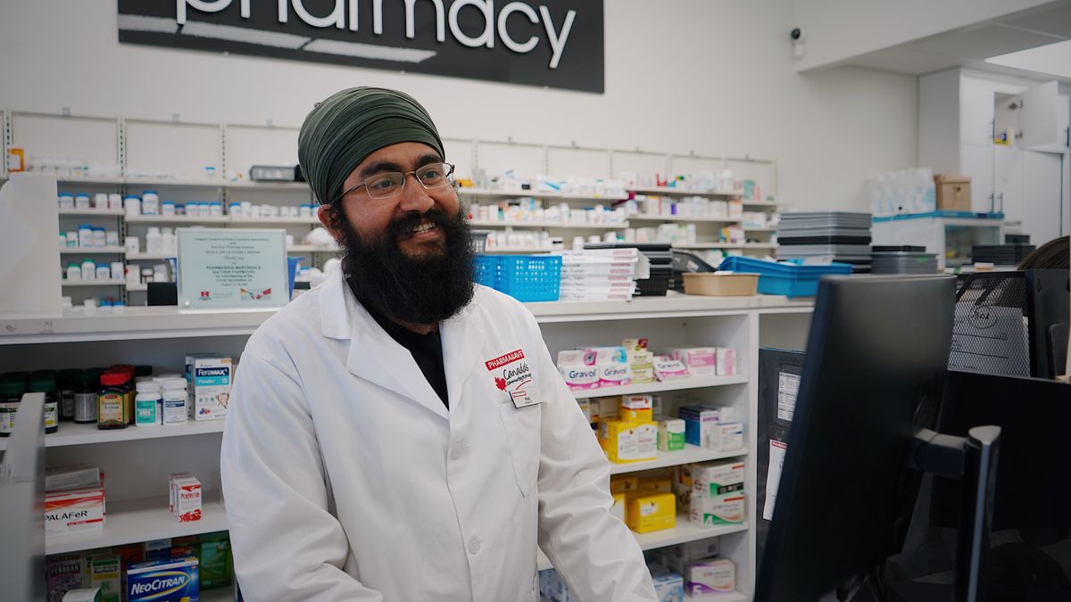 pharmacist reviewing prescription documents at counter