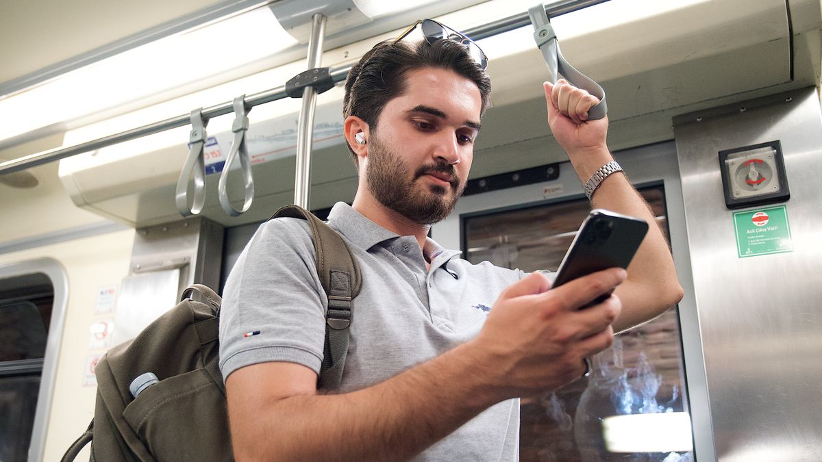 commuter reading smartphone train