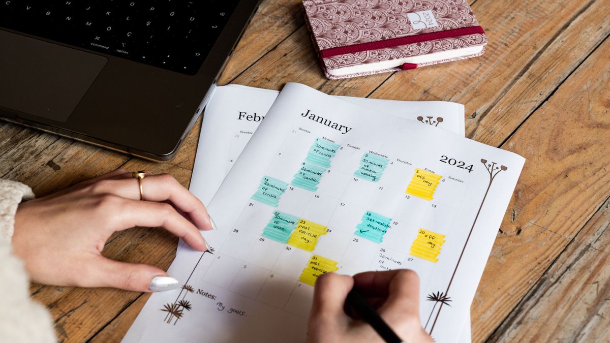person reviewing study schedule calendar laptop