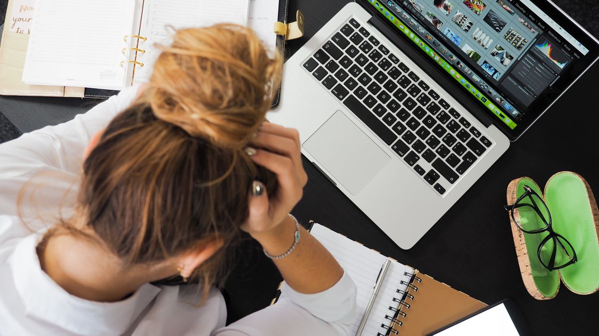 woman studying desk frustrated papers