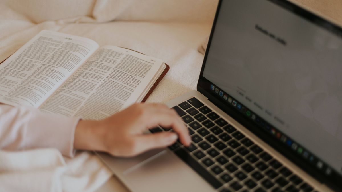 person comparing online course textbook