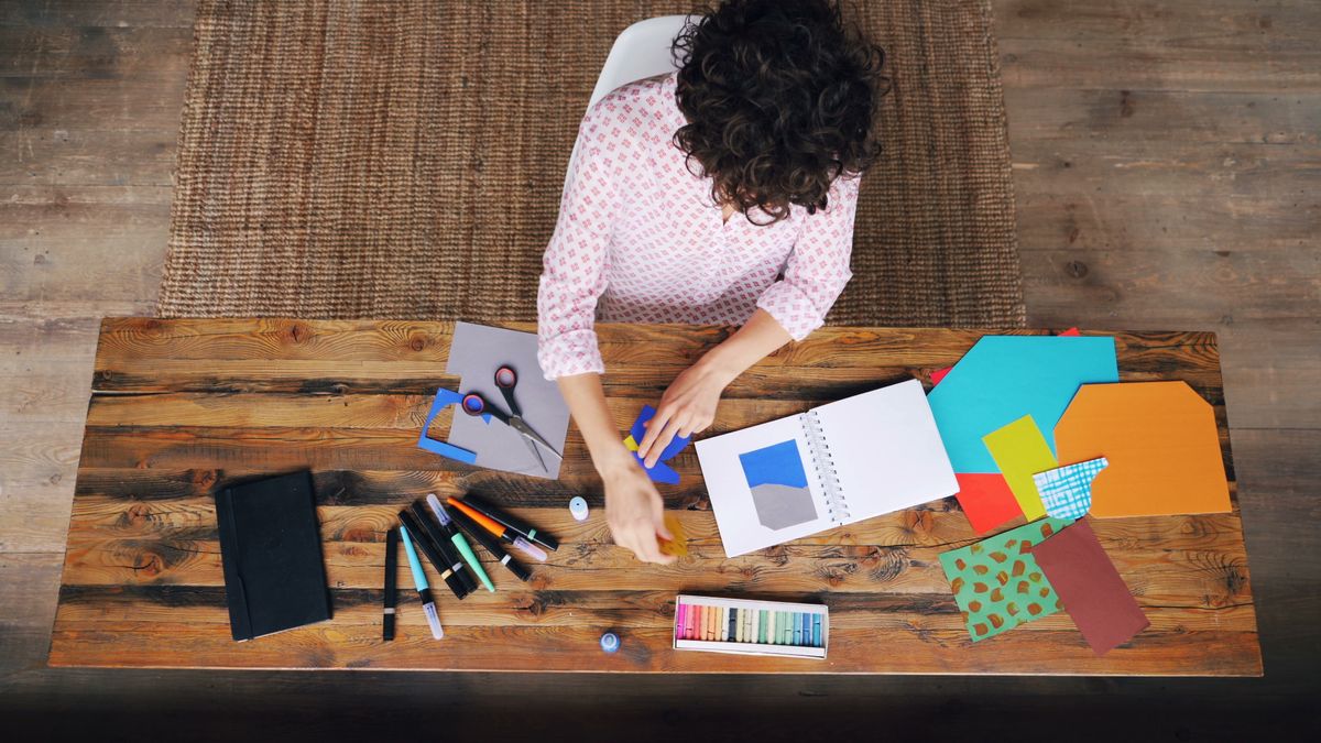 woman studying color palette notebook desk