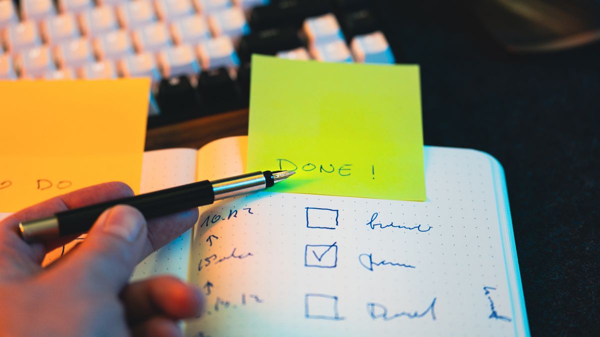 checklist notebook pen desk