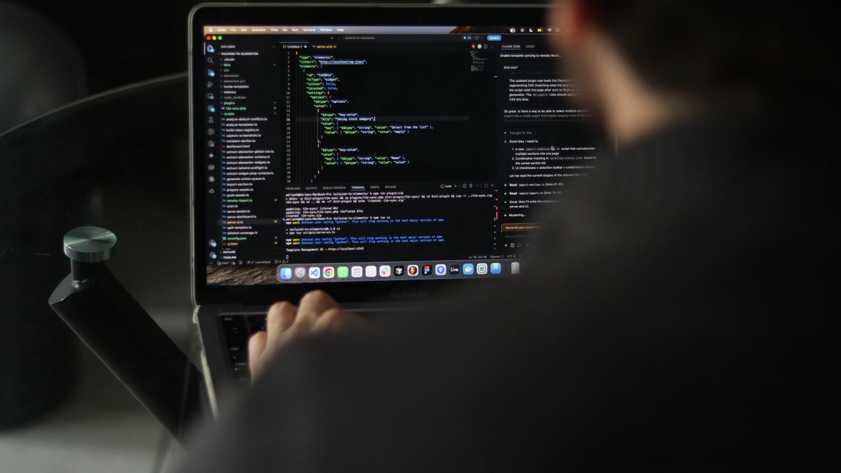 person studying python textbook on laptop