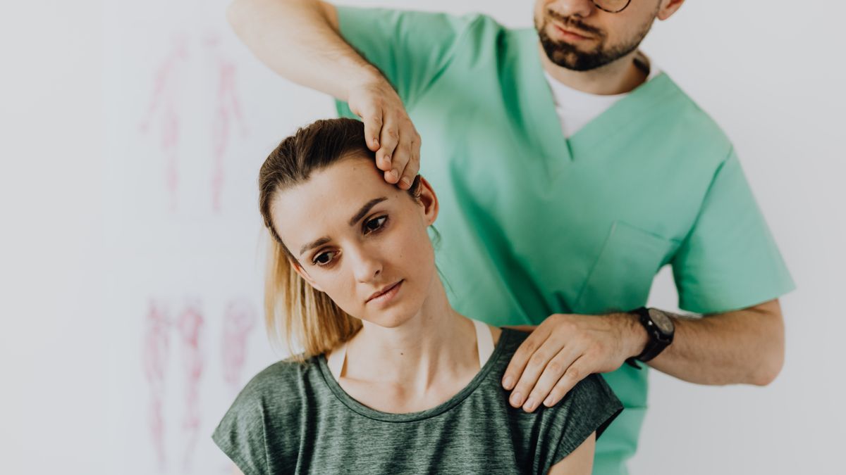 physical therapist treating patient back