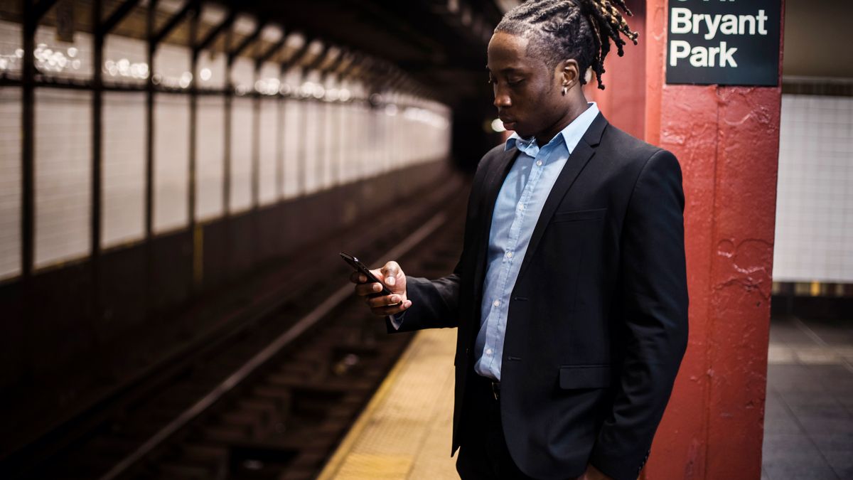 businessman studying smartphone commuter train