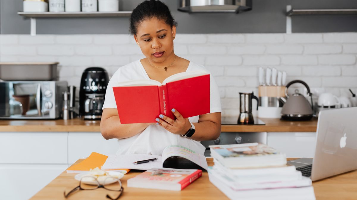 woman studying flashcards at kitchen table