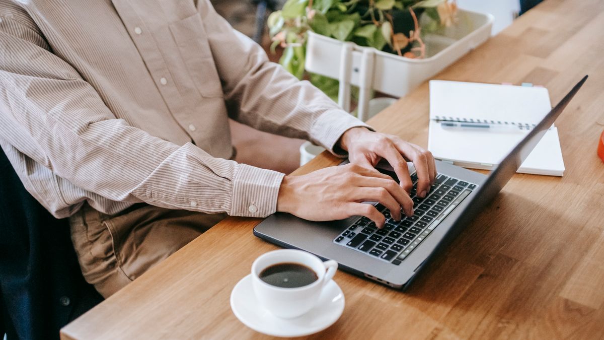 person working on laptop side job at home