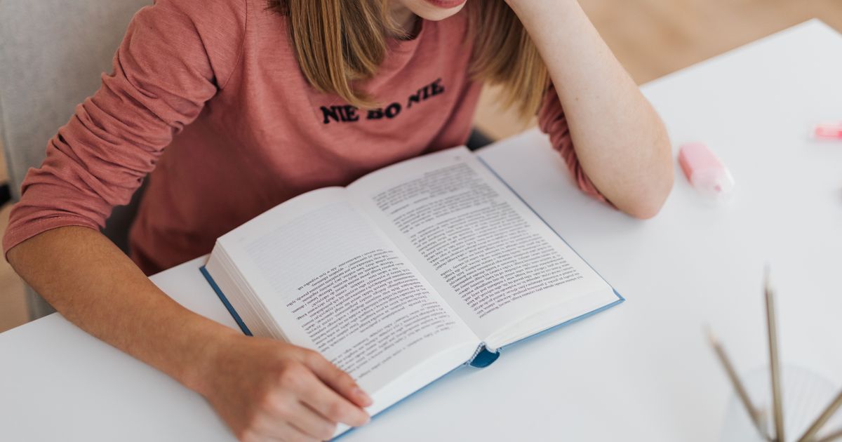 person studying electrical textbook at desk
