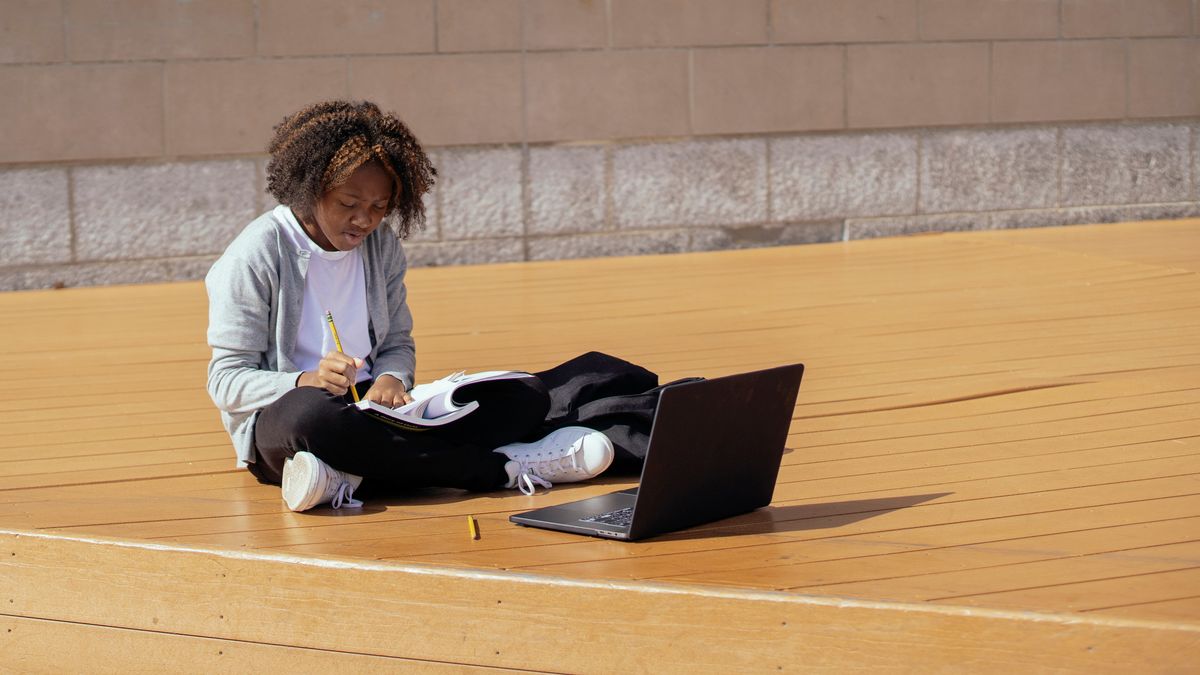 person studying online course laptop