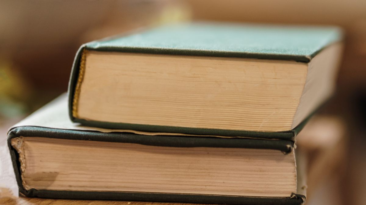 stack of textbooks reference books desk