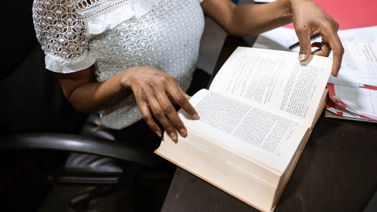 person studying with law textbooks at desk