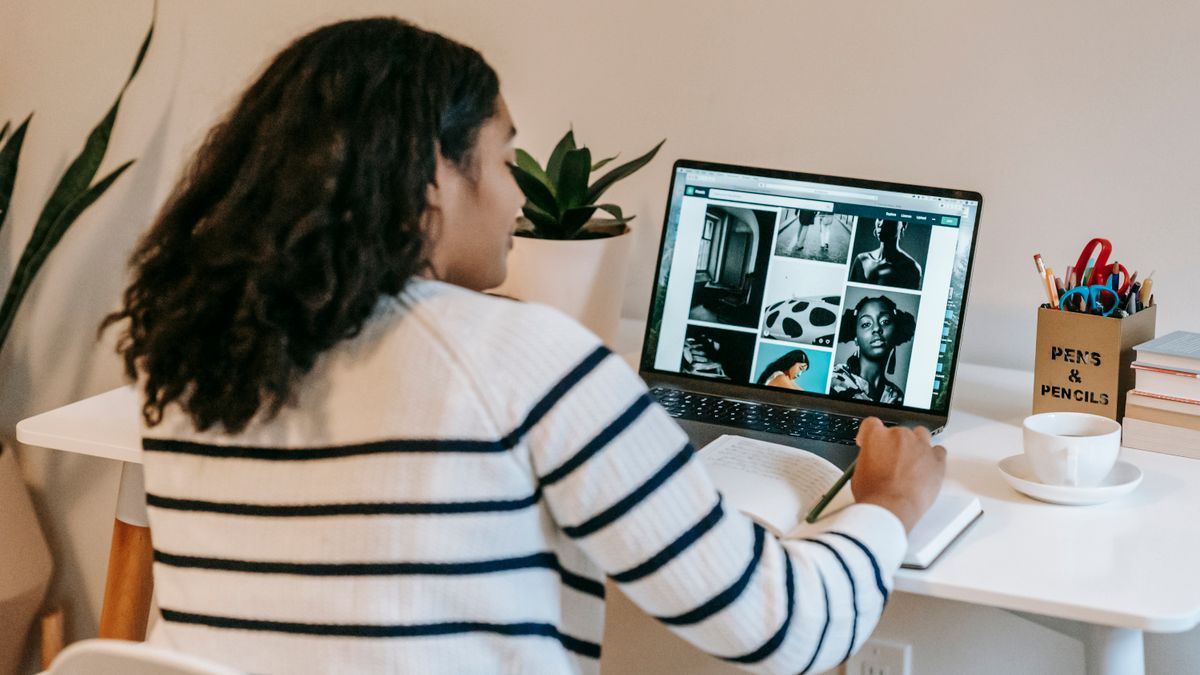 woman studying online course laptop notes desk