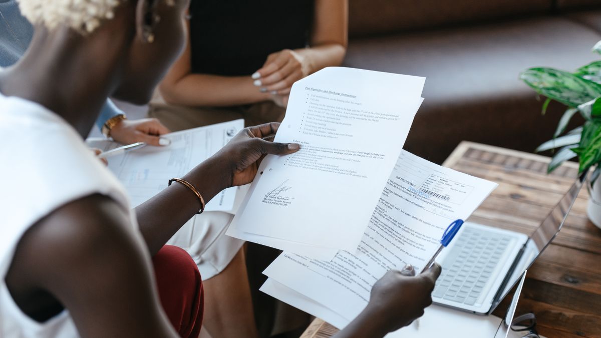 woman comparing certificates documents