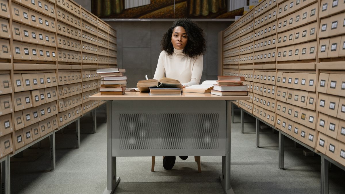 person studying law textbooks at desk in the evening