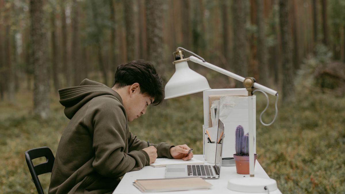 person studying chinese vocabulary flashcards at desk