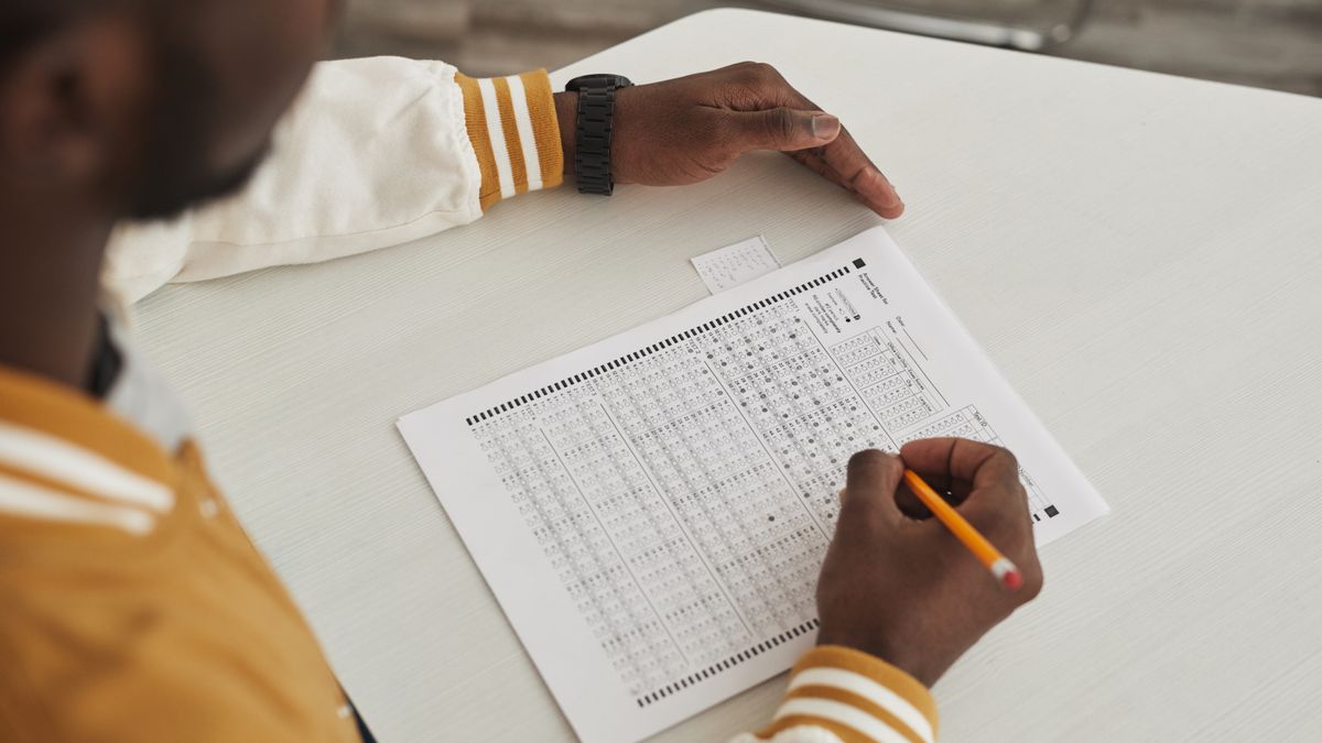 student writing answer sheet exam
