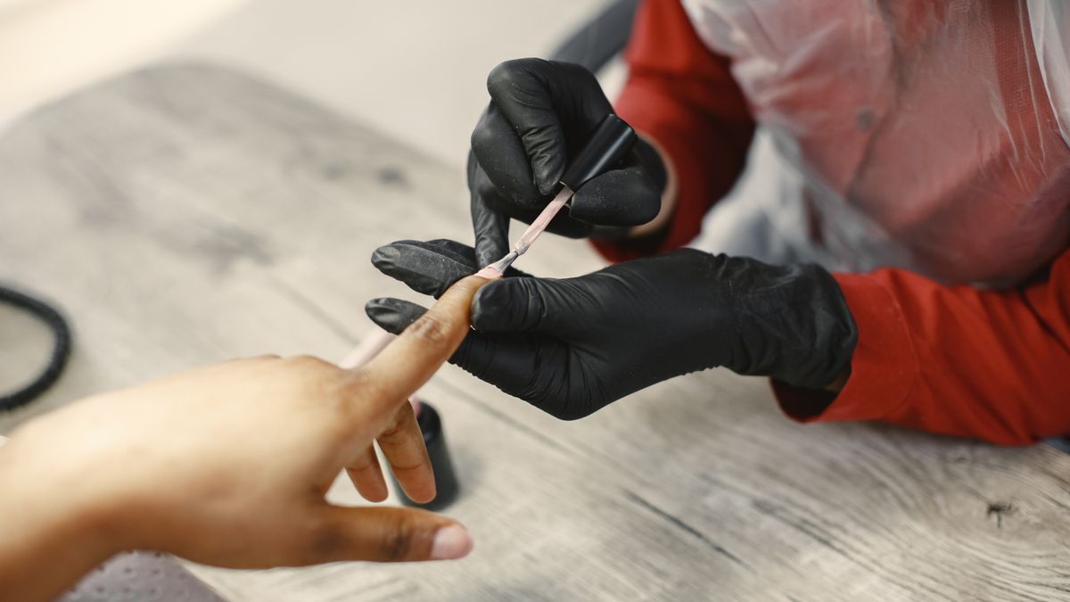 nail technician working client hands