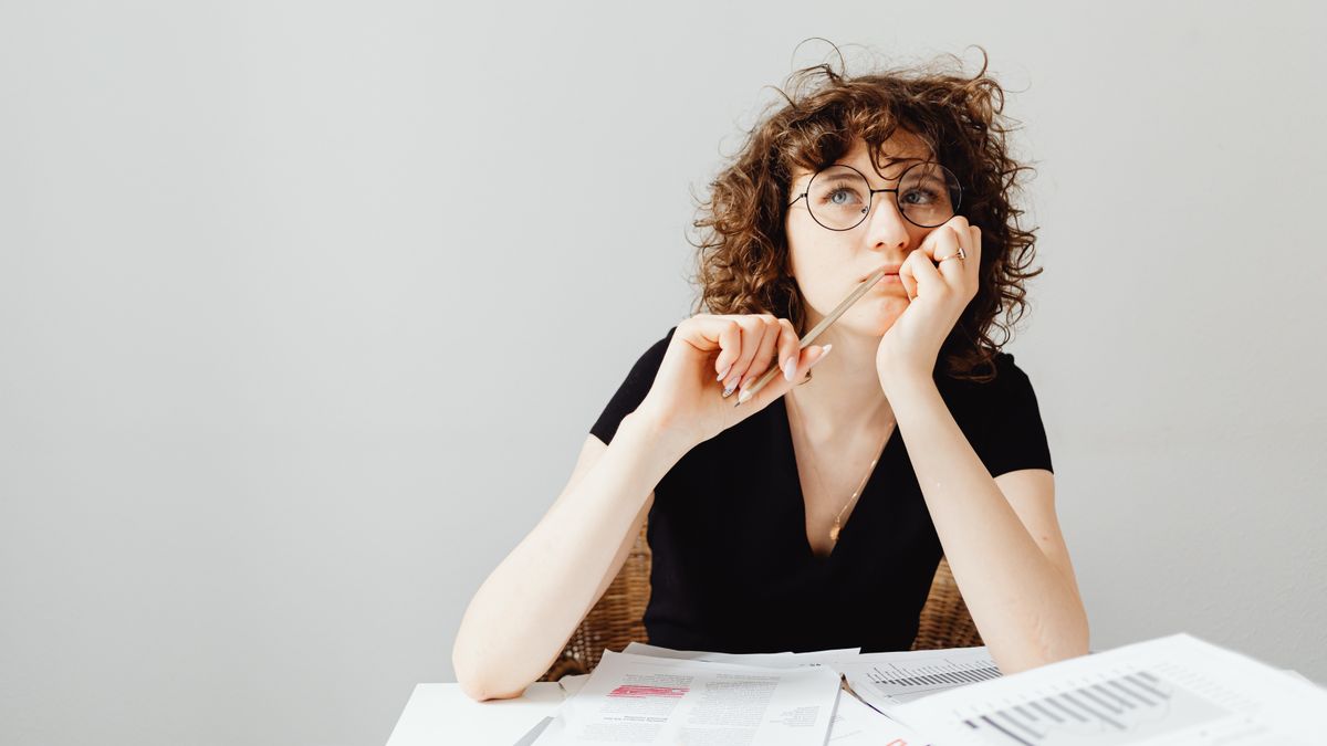 person thinking checklist decision making desk