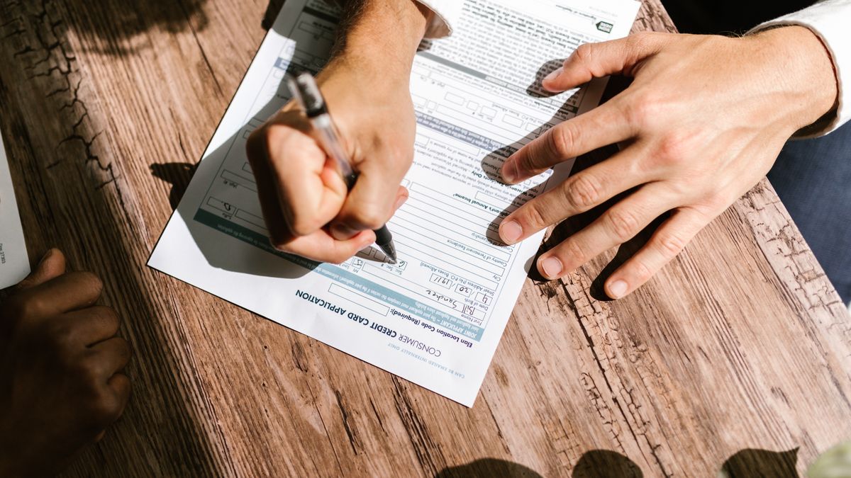 consumer contract paperwork signing at table