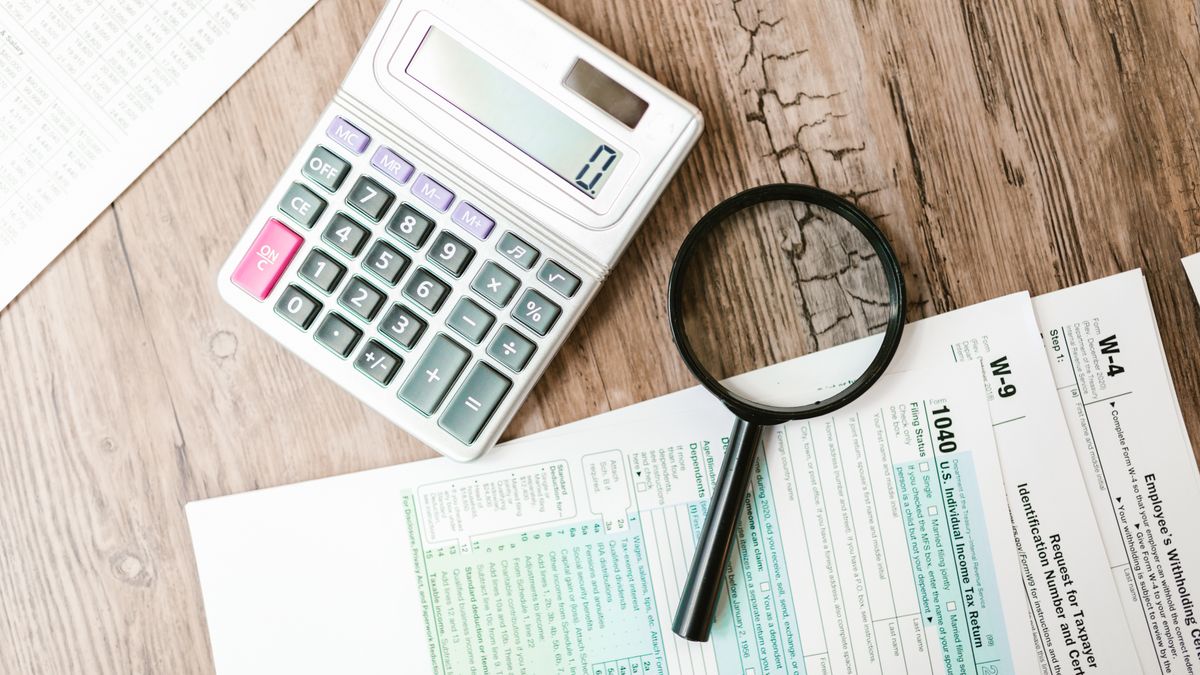 financial documents, calculator, desk
