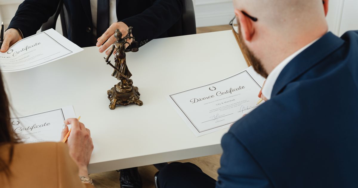 person comparing certificate documents on desk