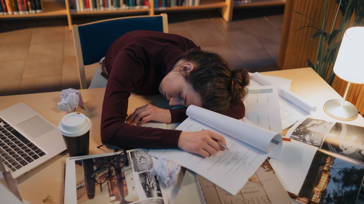 tired man studying at desk night