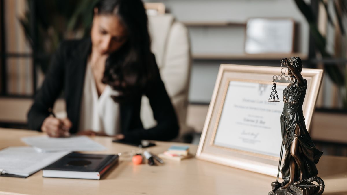 person comparing certificate documents desk
