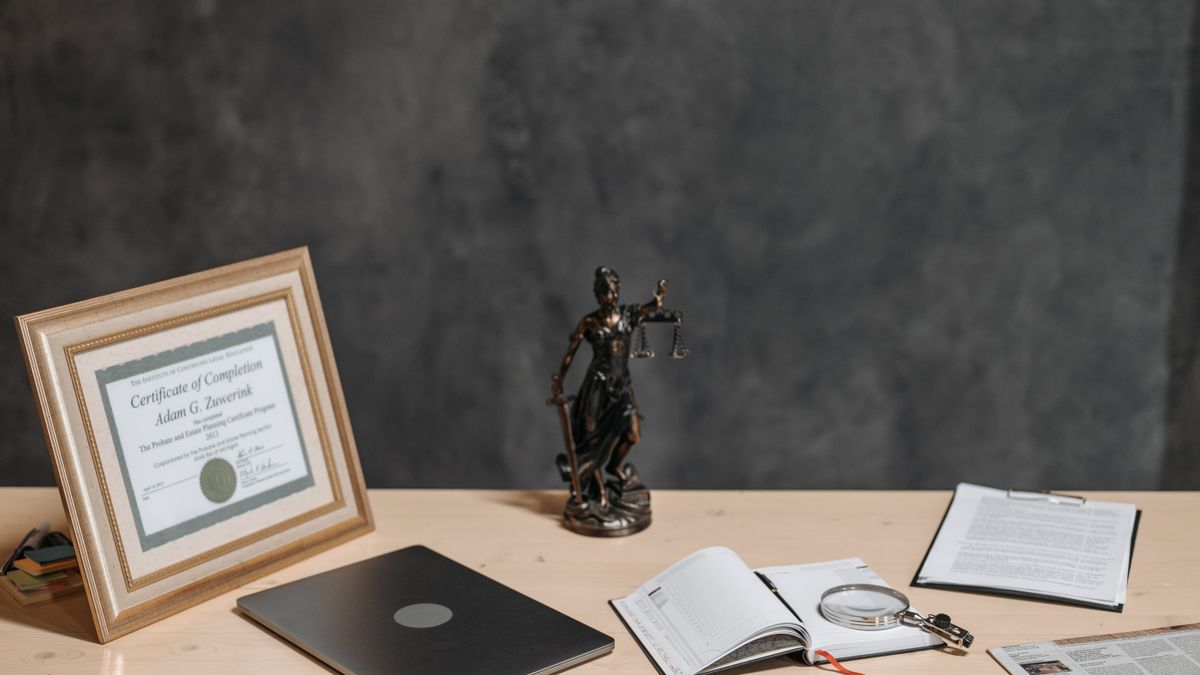 person comparing certificate documents on desk