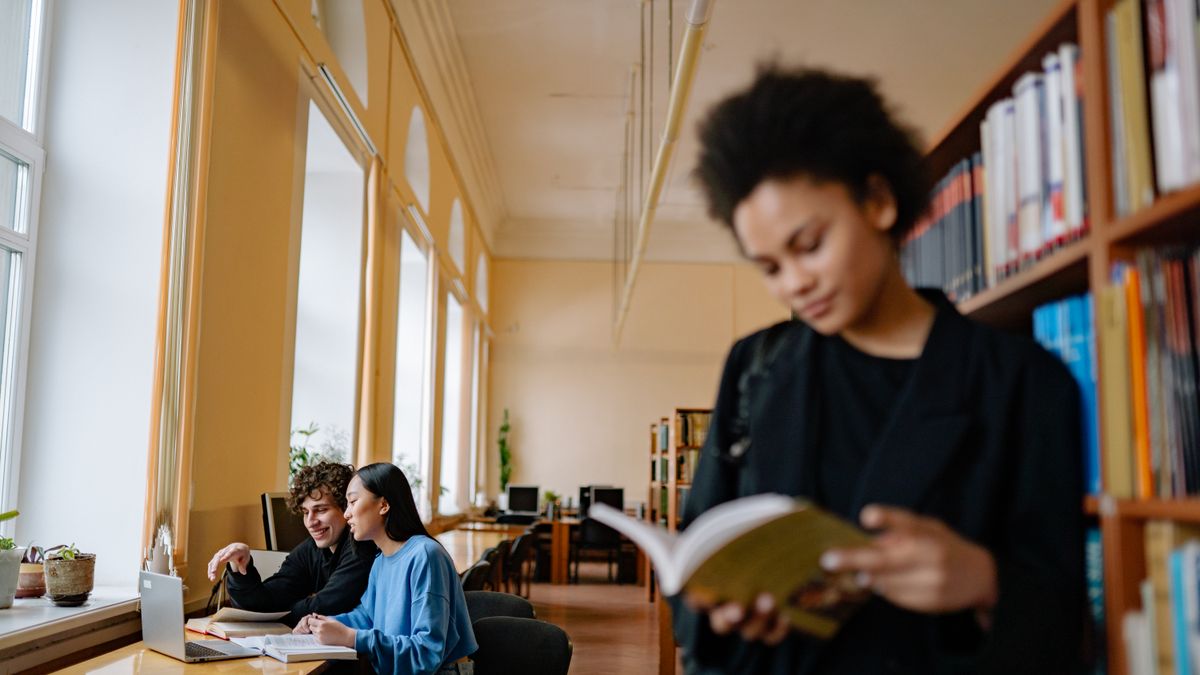 graduate student studying laptop library