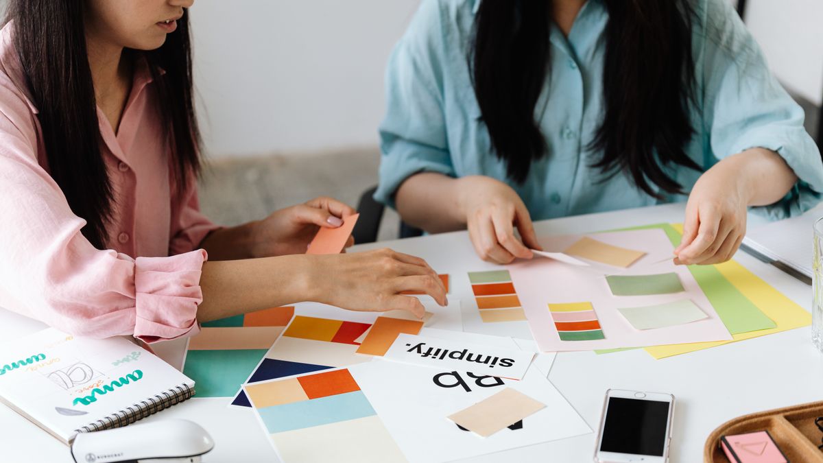woman choosing color swatches at home desk