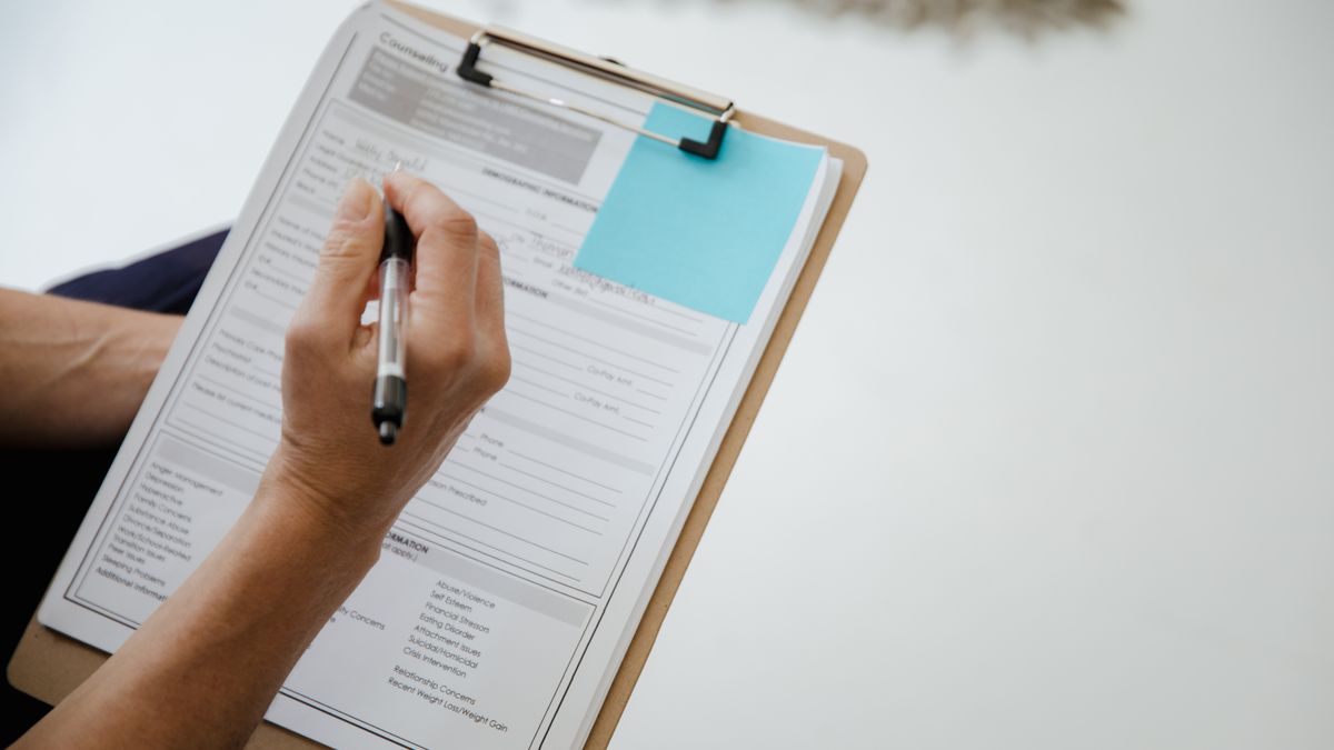 hand filling exam application form calendar