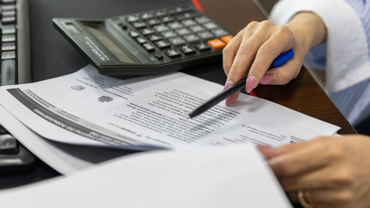 office worker reviewing documents desk