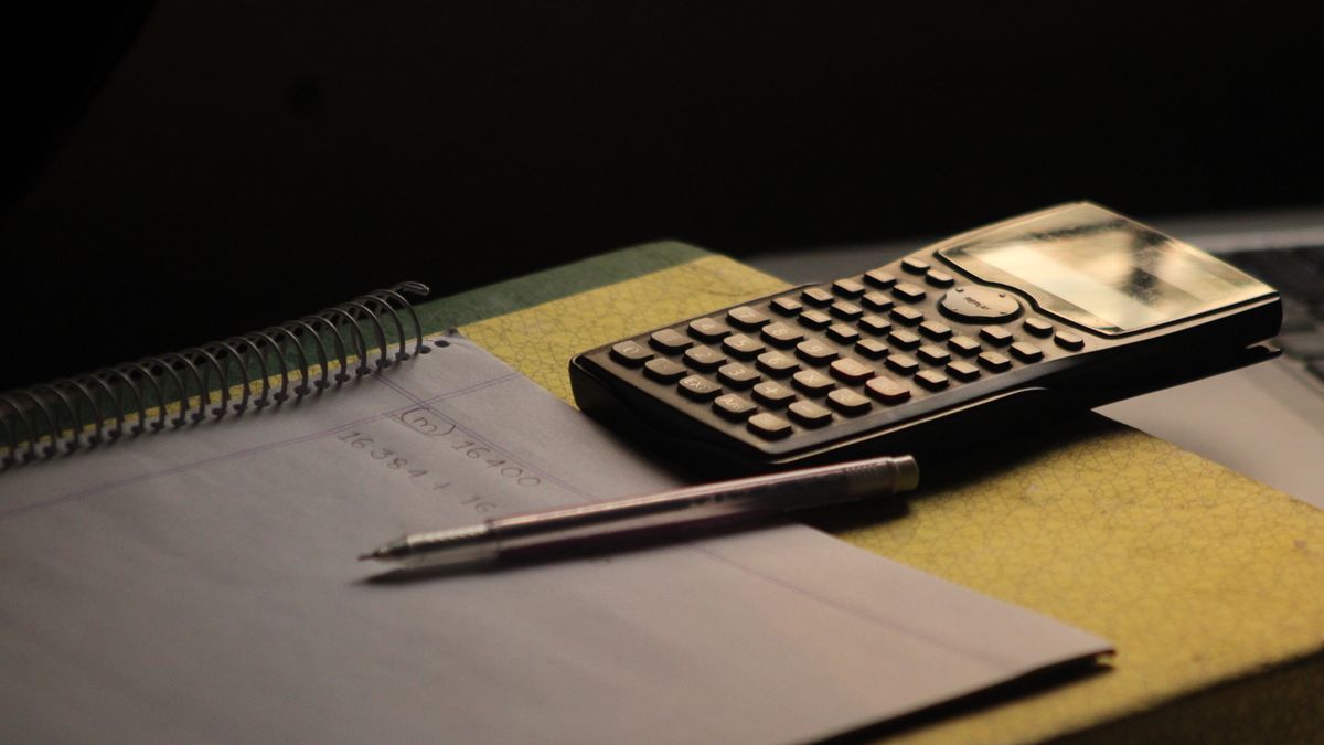 study desk with textbooks, calculator